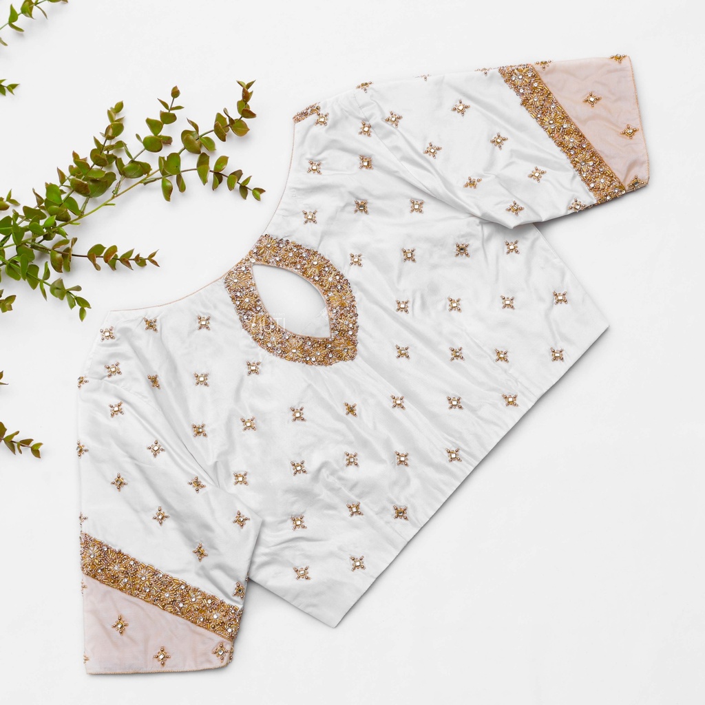 A vision in white, this bridal blouse is elevated with stunning gold embroidery Stitching
