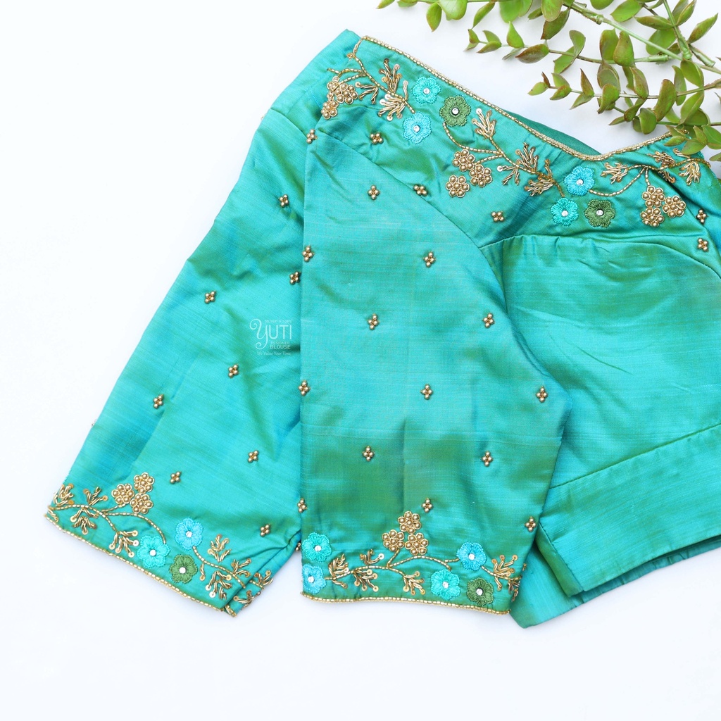 Embrace the beauty of nature with this turquoise blue blouse Stitching