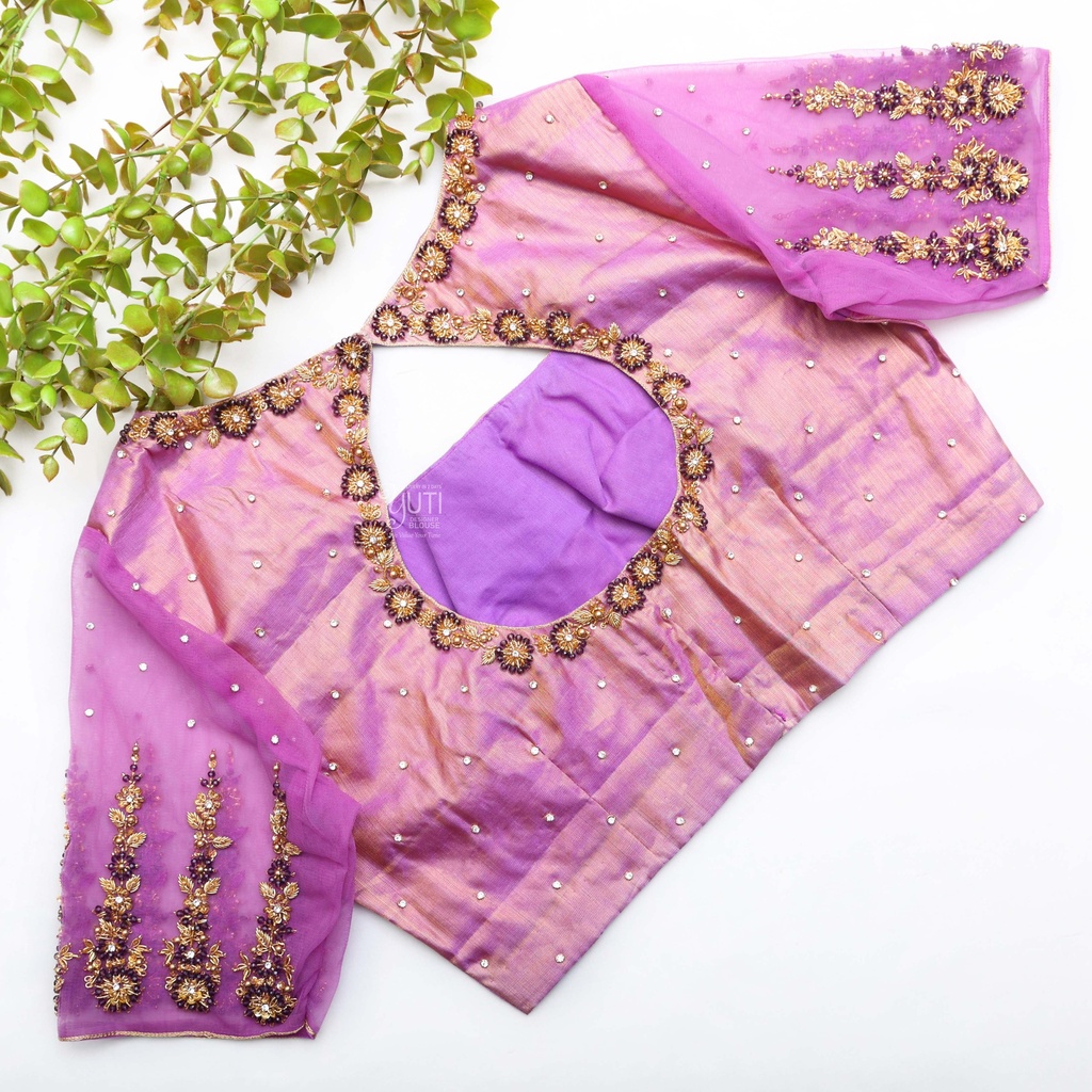 Pink blouse paired with a purple blouse and surrounded by lush greenery Stitching