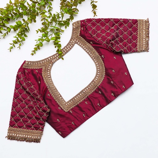 This stunning blouse with gold neck work is stealing the Elegance in maroon Stitching